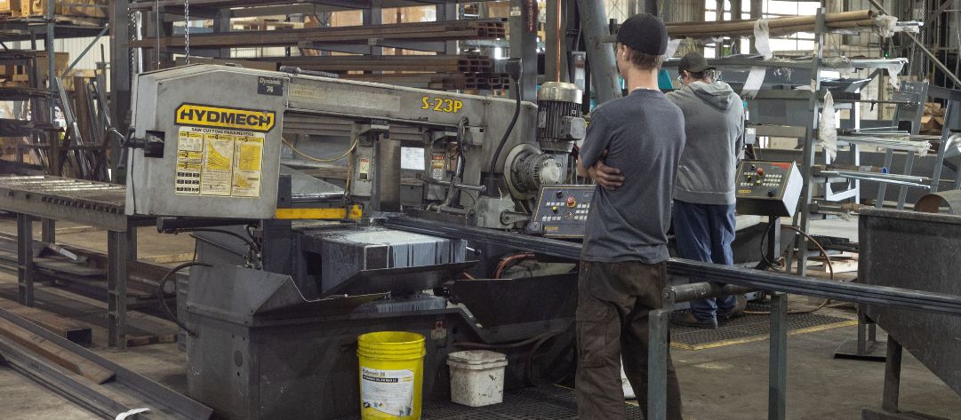 Dynamic Millwrights Inc. worker near machine